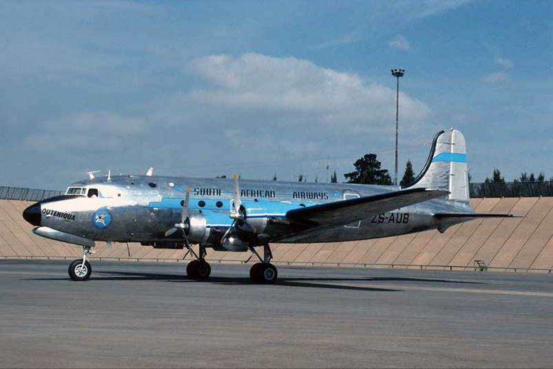 A silver and blue airplane on a runway

Description automatically generated