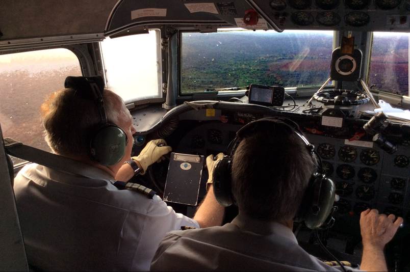 A group of men in a cockpit

Description automatically generated