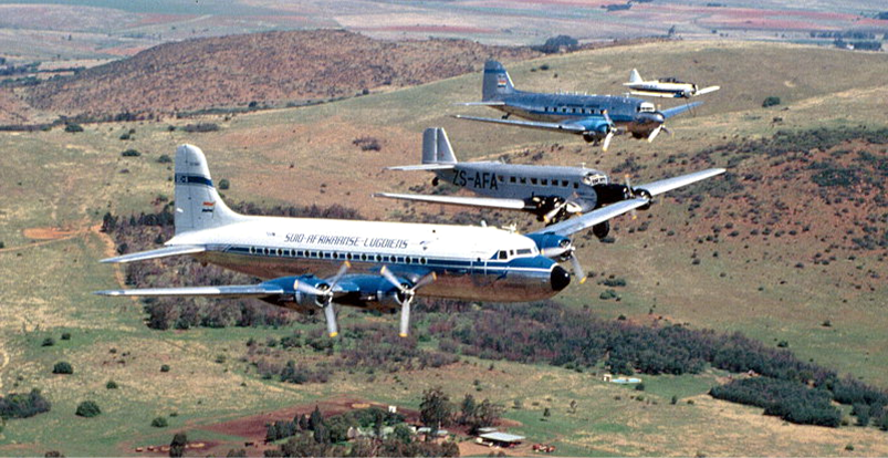 Several airplanes flying over a field

Description automatically generated