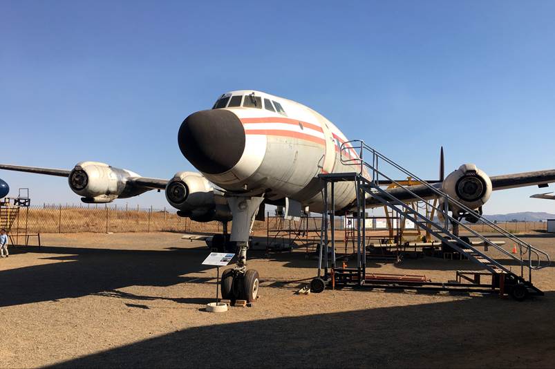 A plane parked on a dirt field

Description automatically generated with medium confidence