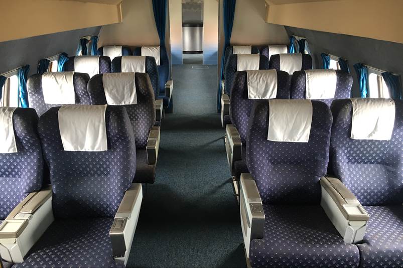 A row of seats in a plane

Description automatically generated