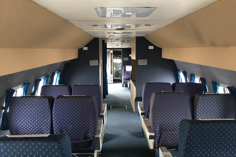 A plane with blue seats

Description automatically generated with medium confidence