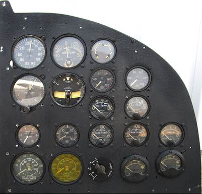 A close-up of a black panel with different gauges

Description automatically generated