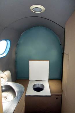 A toilet in a small room

Description automatically generated