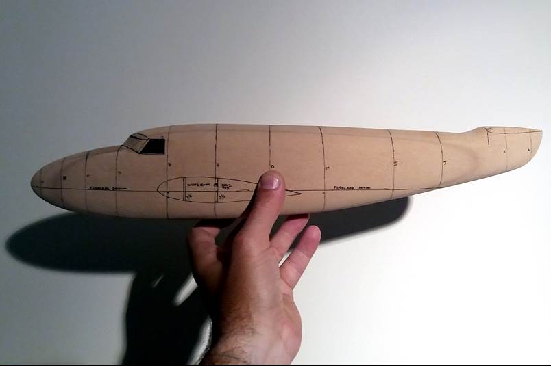 A hand holding a model airplane

Description automatically generated