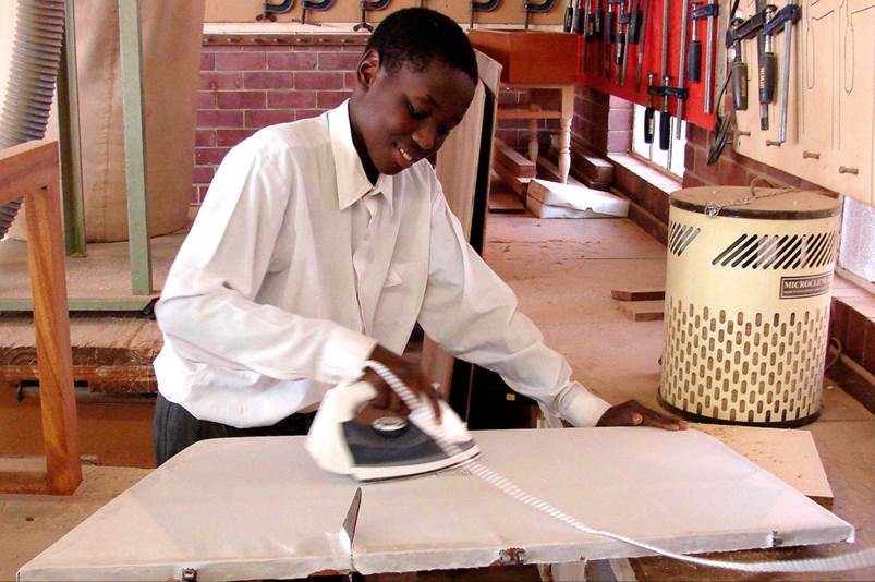 A person ironing a piece of paper

Description automatically generated