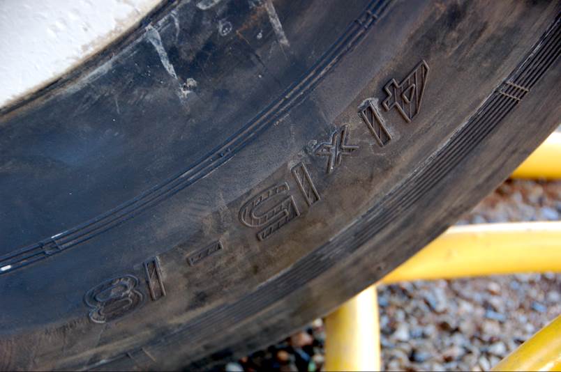 Close-up of a tire with numbers and letters

Description automatically generated