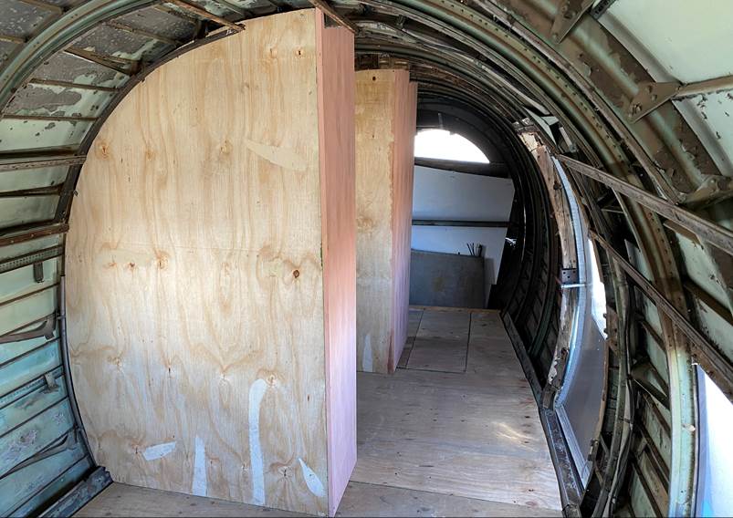 Inside a plane with a wooden door

Description automatically generated with medium confidence