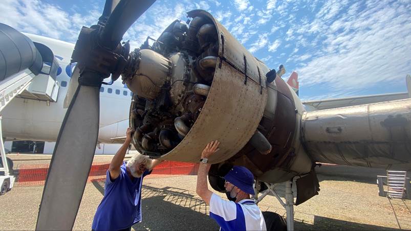 Two men working on an airplane

Description automatically generated