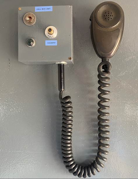 A telephone with a cord attached to it

Description automatically generated