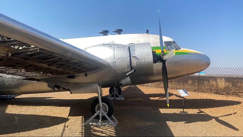 A plane with propellers on the ground

Description automatically generated