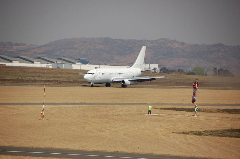 A plane sitting on top of a runway

Description automatically generated