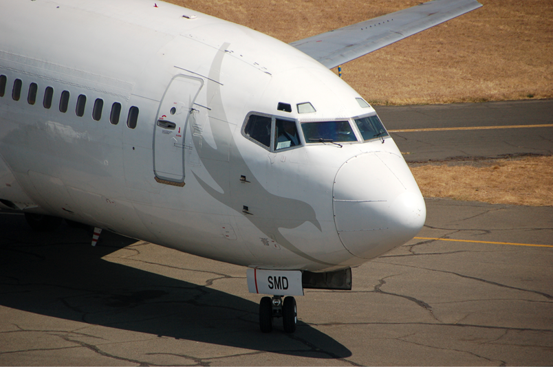 A large passenger jet sitting on top of a runway

Description automatically generated