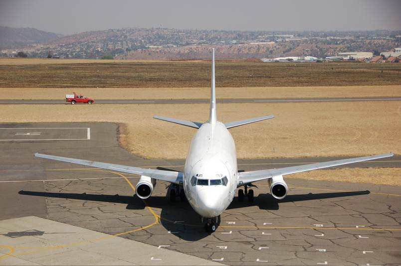 A large passenger jet sitting on top of a runway

Description automatically generated