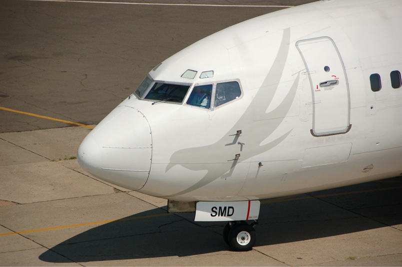 A large passenger jet sitting on top of a runway

Description automatically generated