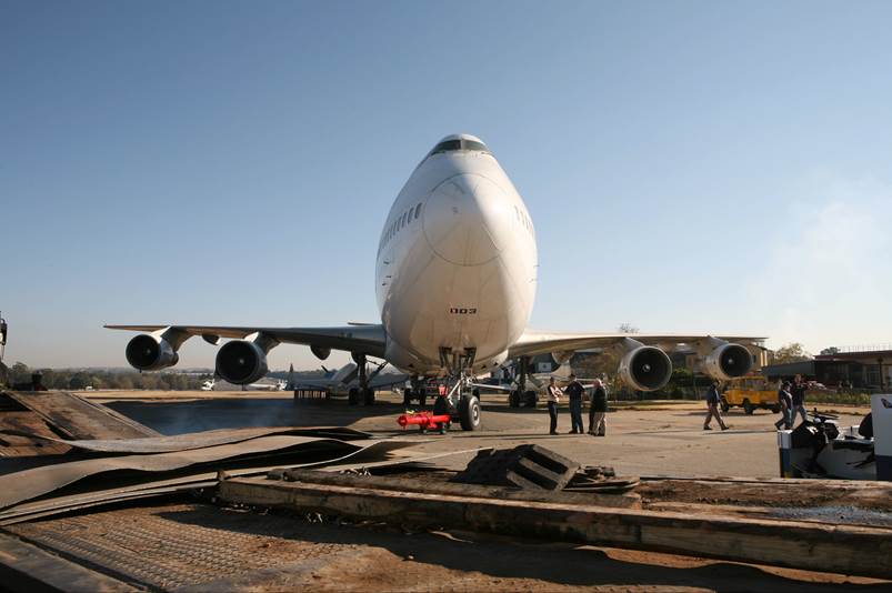 A large white airplane on a runway

Description automatically generated