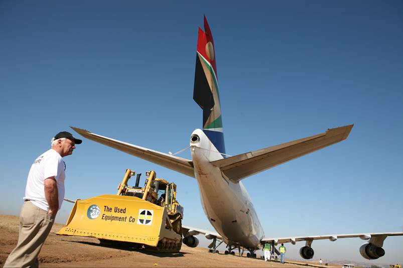 A person standing next to a large airplane

Description automatically generated