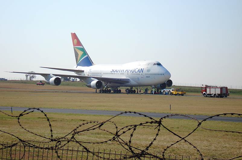 A large passenger jet sitting on top of a runway

Description automatically generated