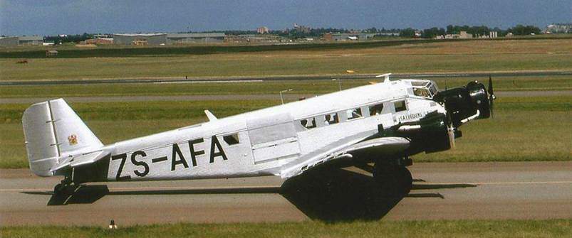 A white airplane on a runway

Description automatically generated