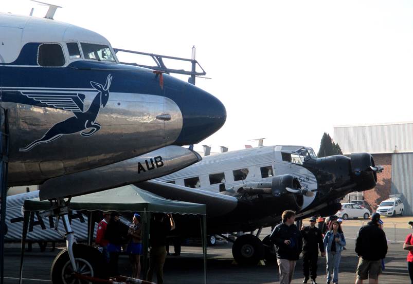 A group of people walking next to a plane

Description automatically generated