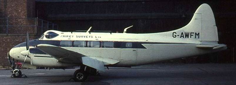 A white airplane parked at an airport

Description automatically generated