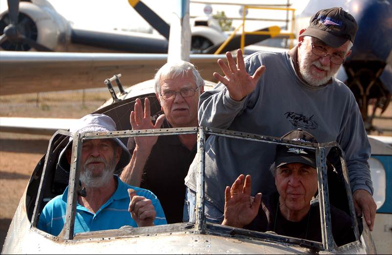 A group of men waving from a boat

Description automatically generated