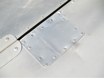 A metal plate with screws

Description automatically generated