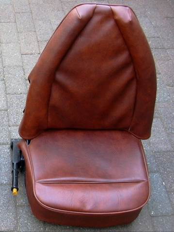 A brown leather chair on a brick surface

Description automatically generated