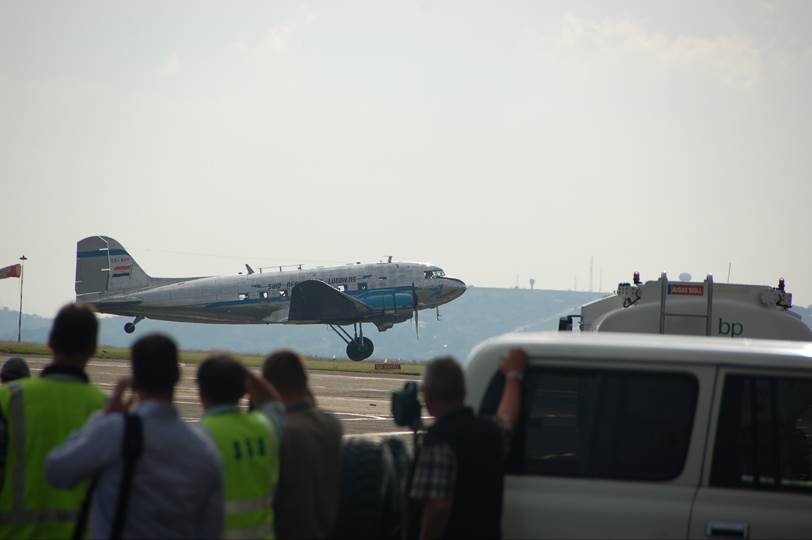 A group of people standing in front of a plane

Description automatically generated