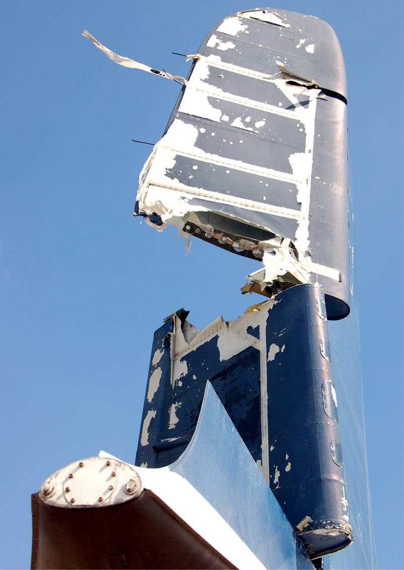 A close-up of a broken airplane tail

Description automatically generated