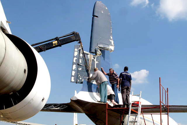 Men standing on a ladder on a plane

Description automatically generated